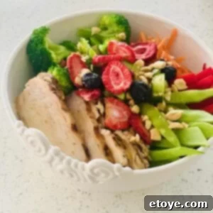 Tropical Grilled Chicken Buddha Bowl with Sweet Mango and Toasted Peanuts 4 Closeup of a vibrant Grilled Chicken Buddha Bowl with mango dressing, roasted peanuts, and fresh berries.