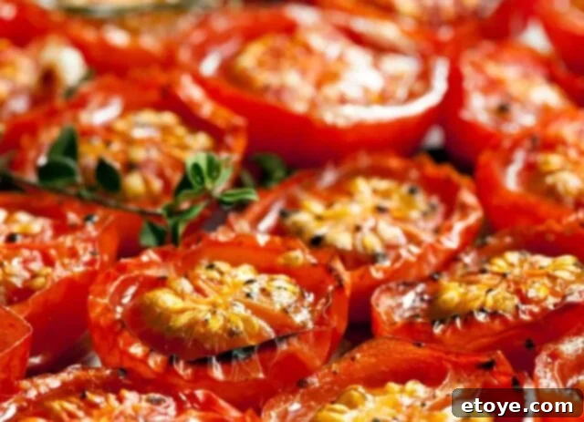 close-up of roasted cherry tomatoes and mellow garlic cloves
