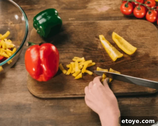 Cut Bell Peppers Perfectly Every Time 4 Different cuts of bell peppers, including strips, dices, and rings, displayed on a cutting board.