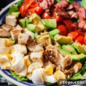 Overhead shot of a vibrant Turkey Cobb Salad in a white bowl