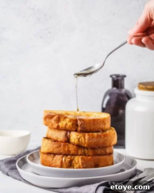 stacked sweet French toast with berries and maple syrup
