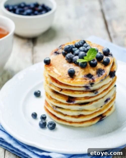 Making the Most of Sour Milk 3 Fluffy blueberry pancakes made with sour milk, served on a white plate