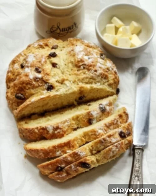 Making the Most of Sour Milk 5 Traditional Irish soda bread on a cutting board with a knife and a bowl of butter