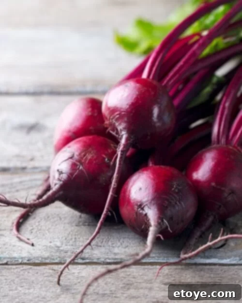 Assortment of vibrant root vegetables including beets, turnips, and parsnips, ready for storage