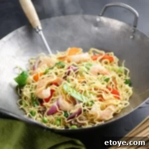 shrimp noodle dish in a wok.