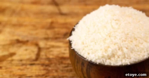 Soft & Sweet Chinese Coconut Buns 5 Close-up of thinner, warmer-toned unsweetened coconut flakes in a bowl, ideal for a purer coconut flavor in baking.