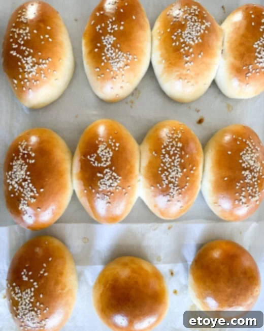 Soft & Sweet Chinese Coconut Buns 7 Freshly baked and cooled Chinese sweet coconut buns resting on a wire rack, showcasing their fluffy texture and perfect golden crust, ready to be enjoyed.