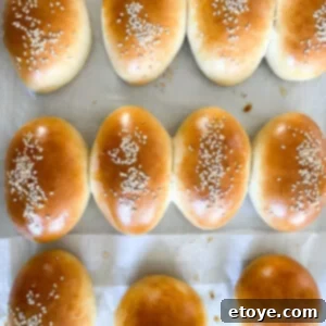 Soft & Sweet Chinese Coconut Buns 8 Delicious Chinese Sweet Coconut Buns Recipe, golden brown and garnished with sesame seeds.