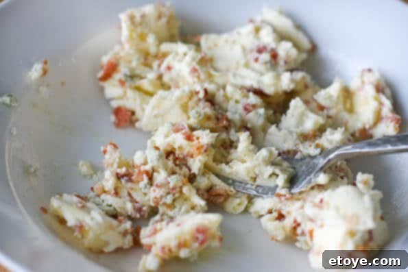 Combine Ingredients for Compound Butter Mixing Softened Butter with Bacon and Blue Cheese