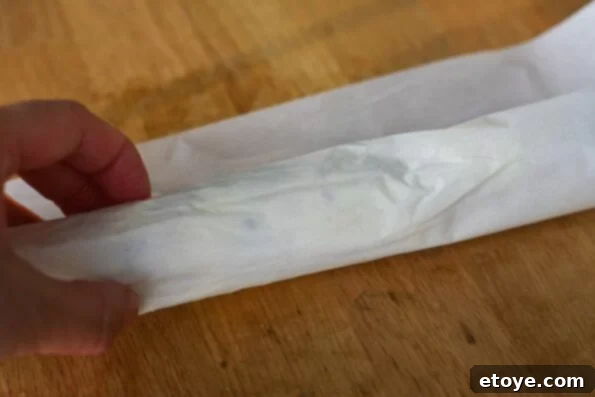 Rolling Butter Log in Parchment Paper Rolling Compound Butter into a Log