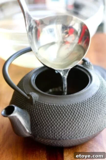 matsutake-dobin-mushi-mushroom-recipe-013 Pouring fresh dashi broth into a traditional Japanese dobin teapot for steaming