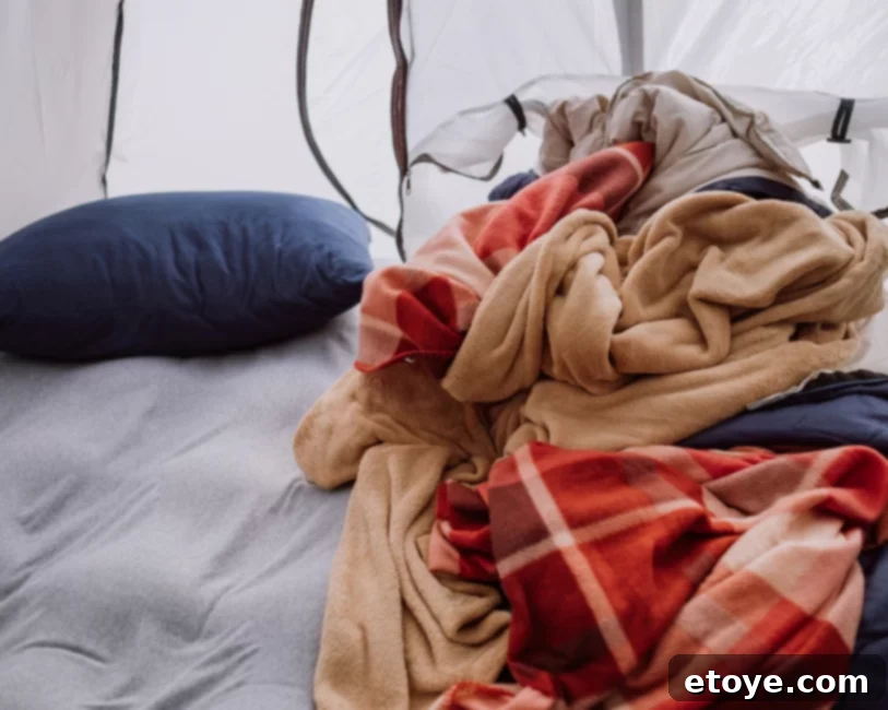 A cozy camping tent set up in a backyard, ready for a comfortable night