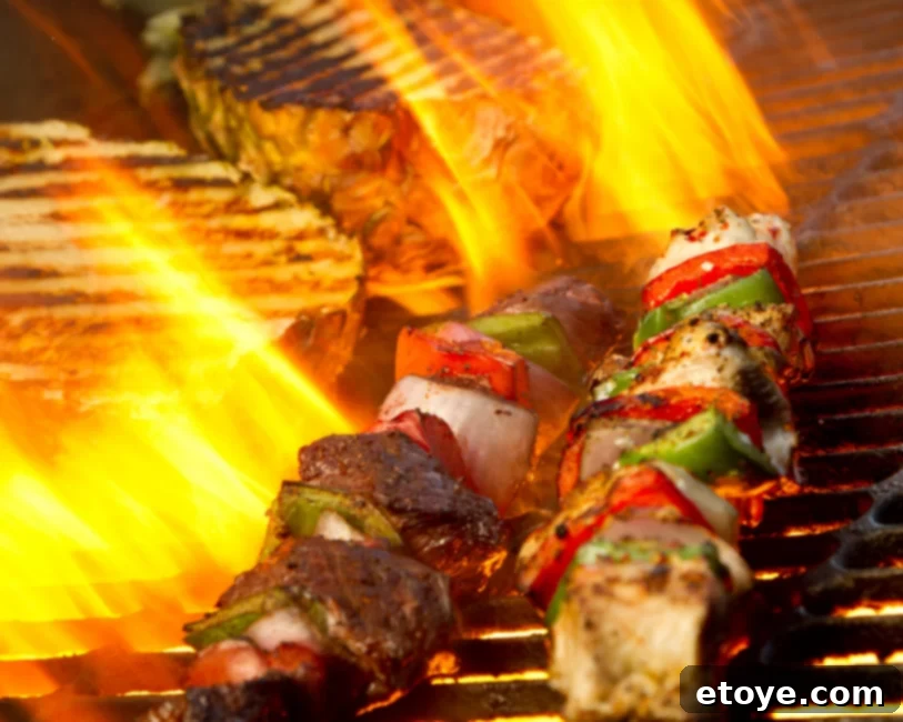 Delicious grilled steak kabobs cooking over an open fire pit