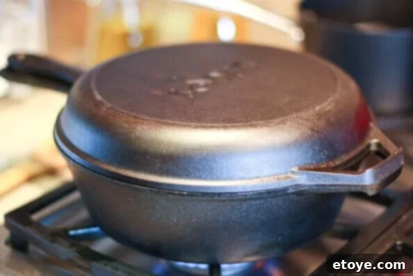 Pioneer Woman Ultimate Buttermilk Fried Chicken 6 Covering frying chicken in a cast iron skillet