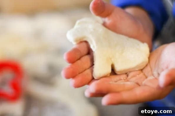 Dog-shaped buttermilk biscuits on a baking sheet, ready for the oven