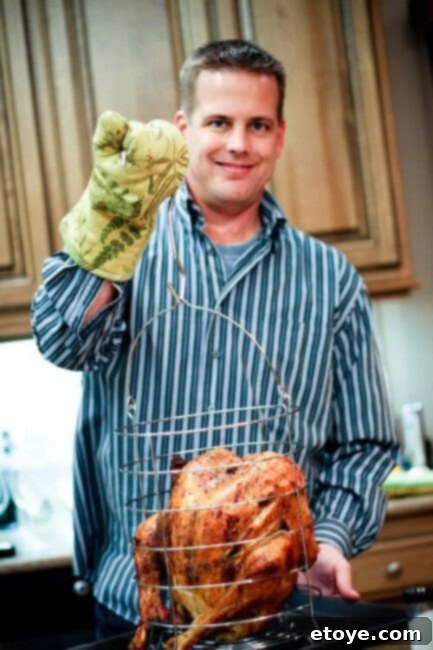 thanksgiving-2009-077 Scott proudly presents the perfectly cooked Thanksgiving turkey from the infrared fryer