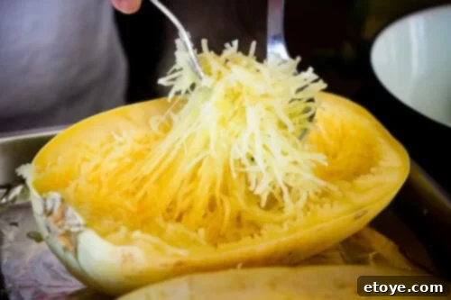 Close-up of spaghetti squash being prepared by Jay