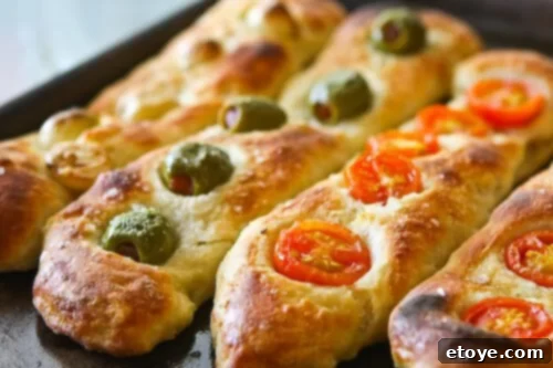 Close-up of a rustic No-Knead Baguette, highlighting its crispy texture and delicious toppings