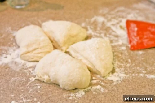 No-Knead Baguette dough divided into four equal portions, ready for shaping
