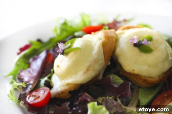 A vibrant salad topped with warm goat cheese rounds on toasted baguette, perfect for a healthy new year.