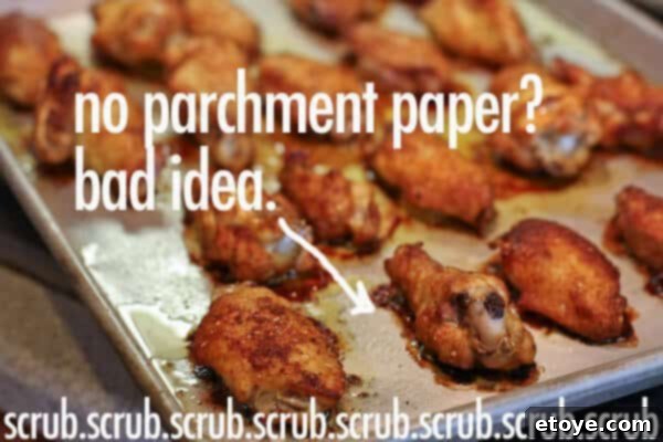 Oven-baked chicken wings arranged on a baking rack on a sheet pan