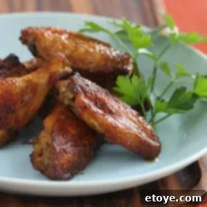 A plate of freshly cooked BBQ Central Smoky Sweet Wings, garnished slightly