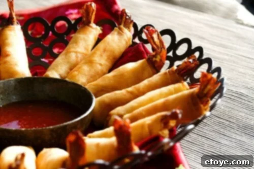 Firecracker Shrimp with Sweet Chili Sauce Close-up of perfectly fried Firecracker Shrimp with Sweet Chili Sauce, showcasing crispy texture