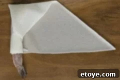 Dynamite Shrimp with Sweet Chili Glaze 4 Close-up of a perfectly sealed firecracker shrimp roll, ready for frying