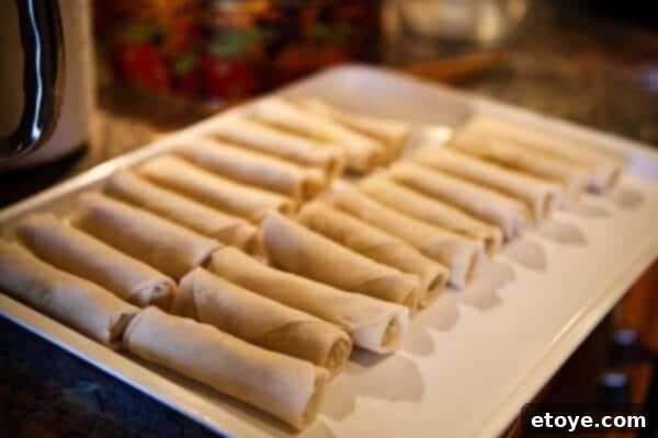 Delicious Homemade Egg Rolls Freshly rolled Chinese egg rolls ready for cooking and freezing.