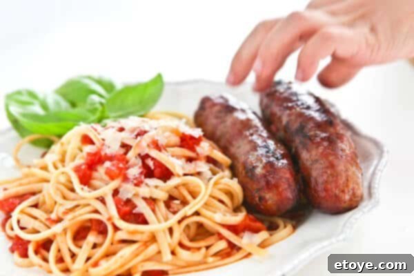 Italian sausages grilling outdoors, with a child impatiently waiting nearby