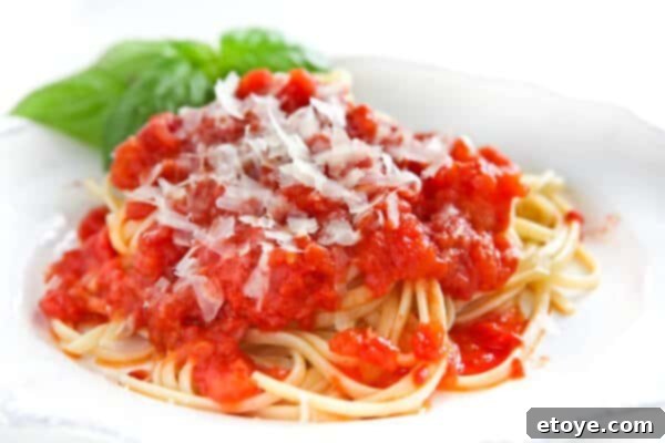 Close-up of pasta generously coated with Marcella Hazan tomato sauce, ready to be enjoyed