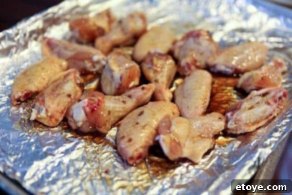 Signature Cola Wings 6 Chicken wings being tossed in a bowl with the rich, syrupy cola glaze