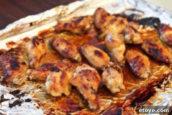 Signature Cola Wings 7 Cola glazed wings baking in the oven, browning and crisping under the broiler