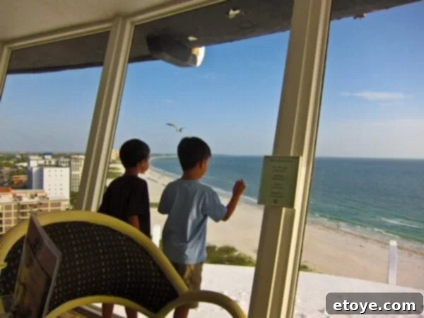 Keep Beaches Clean Forever 4 Close-up of two happy boys smiling and pointing out the window as the restaurant slowly rotates